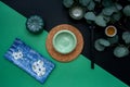 Japanese or Chinese table setting with traditional table mat and dinnerware with green and black background. Royalty Free Stock Photo