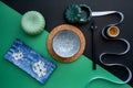 Japanese or Chinese table setting with traditional table mat and dinnerware with green and black background. Royalty Free Stock Photo