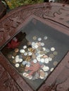 Japanese coins in little stone basin of a shrine. Royalty Free Stock Photo