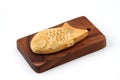 Japanese confectionery Taiyaki fish cake on cutting board on white background Royalty Free Stock Photo