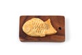 Japanese confectionery Taiyaki fish cake on cutting board on white background Royalty Free Stock Photo