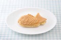 Japanese confectionery taiyaki fish pancake wagashi on plate on table Royalty Free Stock Photo