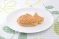 Japanese confectionery taiyaki fish pancake wagashi on plate on table Royalty Free Stock Photo