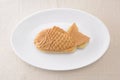 Japanese confectionery taiyaki fish pancake wagashi on plate on table Royalty Free Stock Photo