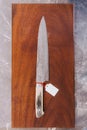 Japanese cook`s knife stainless steel blade wave pattern with empty price tag, Damascus style kitchen knife texture.