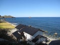 Japanese countryside rocky coast seaside with building and fields Royalty Free Stock Photo