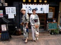 A Japanese couple pose dressed in the traditional kimono at the door of a restaurant in Tokyo
