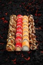 Japanese cuisine. Fresh Sushi rolls set over black background. Japanese seafood sushi. Ebi Roll, philadelphia, californian crab, Royalty Free Stock Photo