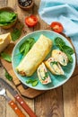 Japanese cuisine. National Japanese dish Omelet tamago yaki for breakfast. Rolled egg with spinach, tomato and cheese.