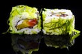 Japanese Cuisine. Pair of Traditional Sushi Rolls With Green Sea Algae Together on Black Reflective Surface Royalty Free Stock Photo