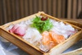 Japanese cuisine sashimi salmon and raw fish sashimi salad on ice served on wooden tray in the Japanese food restaurant Royalty Free Stock Photo