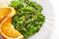 Japanese cuisine. Seaweed salad with orange in white plate Royalty Free Stock Photo