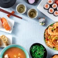 Japanese cuisine square frame with copy space. Tea, sushi, noodles and miso soup Royalty Free Stock Photo