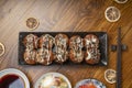 Japanese cuisine Takoyaki octopus balls with takoyaki sauce on wooden table, Traditional Japanese food. Royalty Free Stock Photo