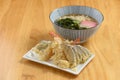 japanese cuisine Tempura Udon noodle with vegetable in dish and bowl isolated on wooden background top view Royalty Free Stock Photo