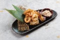 Japanese deep fried squid mixing tempura flour Squid Karaage served with sauce in black plate washi Japanese paper