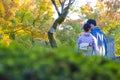 Japanese Destinations. Couple of Japanese Geishas in Traditional Silk Kimonos Posing in Garden of Kyoto City, Japan