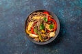 Japanese dish buckwheat soba noodles with chicken and vegetables carrot, bell pepper and green beans in grey bowl, top view, copy Royalty Free Stock Photo