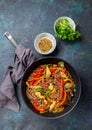 Japanese dish buckwheat soba noodles with chicken and vegetables carrot, bell pepper and green beans in wok on dark blue Royalty Free Stock Photo