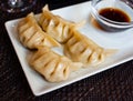 Japanese dish - dumplings gyoza with soy sauce on white plate Royalty Free Stock Photo