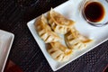 Japanese dish - dumplings gyoza with soy sauce on white plate Royalty Free Stock Photo
