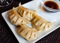 Japanese dish - dumplings gyoza with soy sauce on white plate Royalty Free Stock Photo