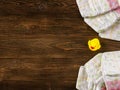 Diapers and rubber duckling on wooden background Royalty Free Stock Photo