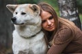 Japanese dog Akita inu portrait with young woman outdoors Royalty Free Stock Photo