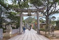 Japanese family on the SandÃÂ path of Miyajidake Shrine overlooked by Torii portals with the Miyaji Mount in fukutsu.