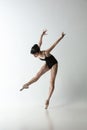 Japanese female ballet dancer, ballerina dancing  on light gray studio background. Art, motion, action Royalty Free Stock Photo