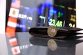 Japanese five hundred Yen coins on reverse JPY on reflex floor with black wallet and digital board of currency exchange money. Royalty Free Stock Photo