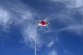 The Japanese flag fluttering against the blue sky. In Japan called \'Hinomaru\'.