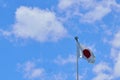 Japanese flag flying in blue sky background