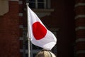 Japanese flag in front of an old building