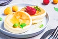 Japanese fluffy pancakes with raspberries in gray plate, gray background. Japanese cuisine concept