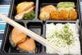 Japanese food bento box rice and fried salmon and vegetables with other cuisine on table Royalty Free Stock Photo