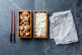 Japanese food. Chicken teriyaki with rice in wooden bento lunch box. slate background, top view. Royalty Free Stock Photo