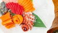 Japanese food combo set. Salmon, tuna sashimi, giant octopus and Crab sticks serve with crushed ice in white plate on restaurant Royalty Free Stock Photo