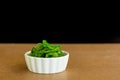 Japanese food concept. Fresh seaweed salad with sesame seeds in white bowl on black background Royalty Free Stock Photo