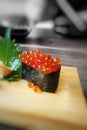 Ikura sushi on wooden plate- blurry black-and-white background. Royalty Free Stock Photo