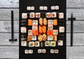 Set of sushi, maki and rolls on gray wood background Royalty Free Stock Photo
