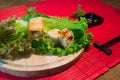 Japanese food restaurant platter set. Hand take roll. Set for two with chopsticks, ginger, soy, wasabi. Sushi at rustic wood backg Royalty Free Stock Photo