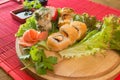 Japanese food restaurant platter set. Hand take roll. Set for two with chopsticks, ginger, soy, wasabi. Sushi at rustic wood backg Royalty Free Stock Photo