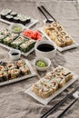 Japanese food restaurant sushi maki roll plate or platter set with soy sauce and wasabi on grey table Royalty Free Stock Photo