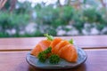 Japanese food sashimi salmon in black plate decoration with vegetable on wooden table. Royalty Free Stock Photo