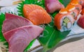 Japanese food set served on white plate. Salmon sushi and sashimi on restaurant table. Fresh raw fish meat sliced and Japan