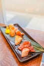 Japanese food, set of sushi put on a rectangular plate placed on wooden table Royalty Free Stock Photo