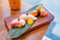 Japanese food, set of sushi put on a rectangular wooden plate and a cup of green tea beside