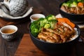 Japanese Food Style : Top view of Homemade Chicken Teriyaki grilled with rice , carrot , broccoli put on the black bowl and place Royalty Free Stock Photo