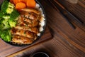 Japanese Food Style : Top view of Homemade Chicken Teriyaki grilled with rice , carrot , broccoli put on the black bowl and place Royalty Free Stock Photo